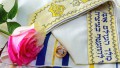 Wedding rings and roses on prayer shawl