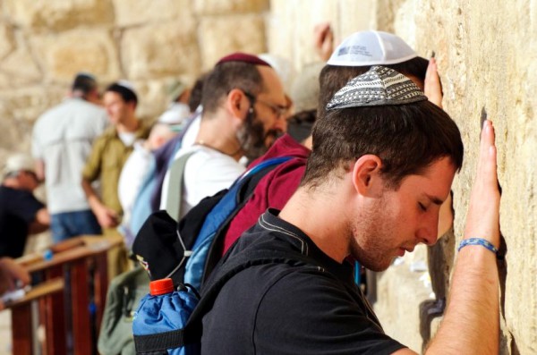 Jewish men pray in the men's section at the Western (Wailing) Wall.