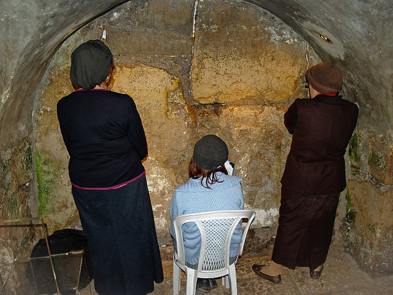 Women praying in the Western Wall tunnels, which expose an additional 485 metres of the Wall.  This is a spot in the tunnel where Jewish women can be physically the closest to where the Holy of Holies once stood.
