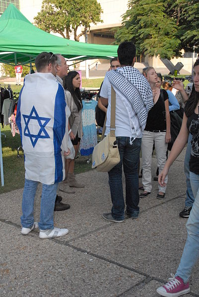 student-Israeli flag-Arabic keffiyeh-Tel Aviv University