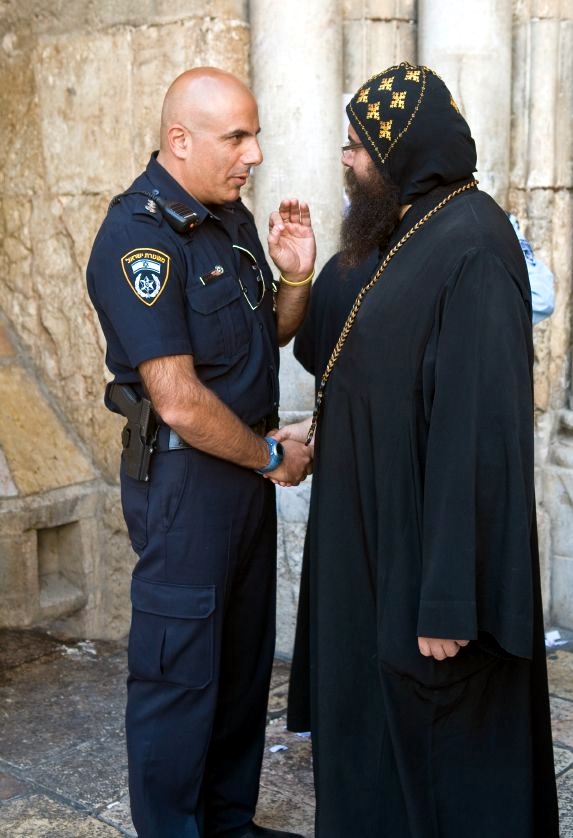 Coptic-priest-speaks-with-an-Israeli-police-officer-at-the-Church-of-the-Holy-Sepulcher-in-Jerusalem