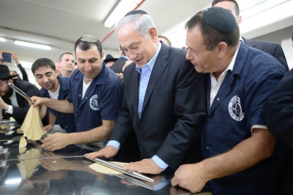 Prime Minister Benjamin Netanyahu learns how to make kosher-for-Passover matzah.