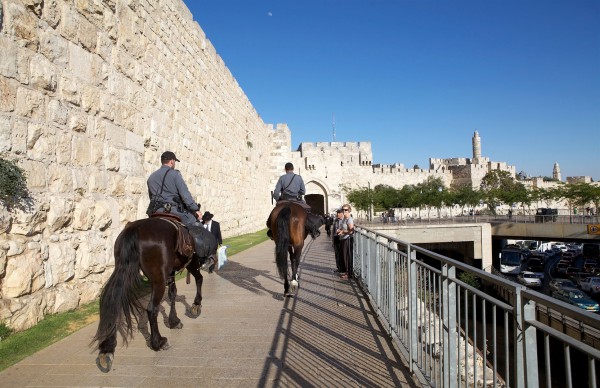 Israeli border police ride horses along the fortified wall of the Old City of Jerusalem. Jerusalem-horses
