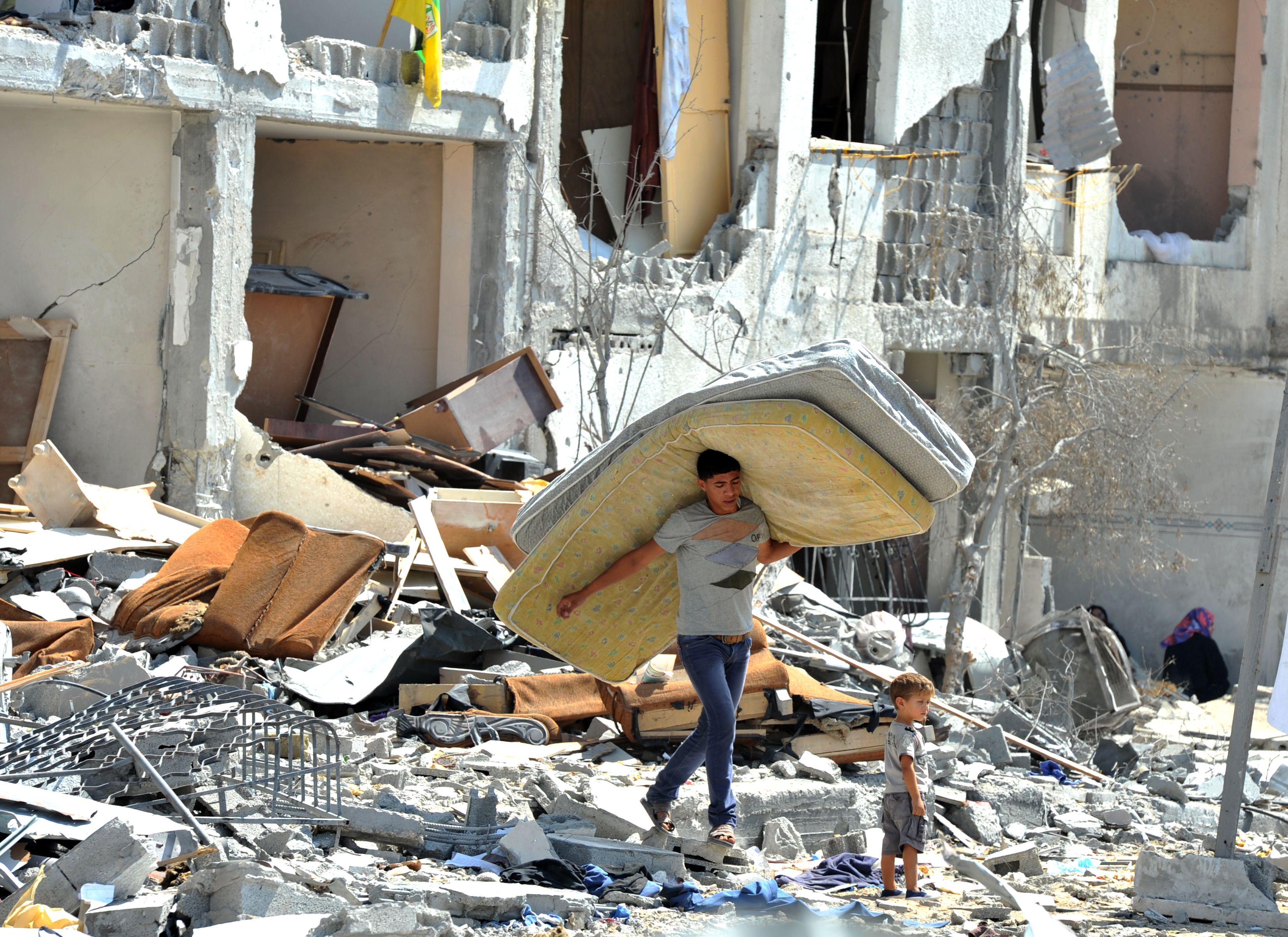 A Palestinian searches through rubble of his destroyed home in Towers Al-andaa in the northern Gaza Strip.