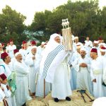 Samaritans lift the Torah on Mount Gerizim during Shavuot, otherwise called Pentecost or the Feast of Weeks.