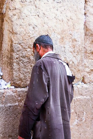 A homeless man in Israel prays at the Western (Wailing) Wall in Jerusalem.