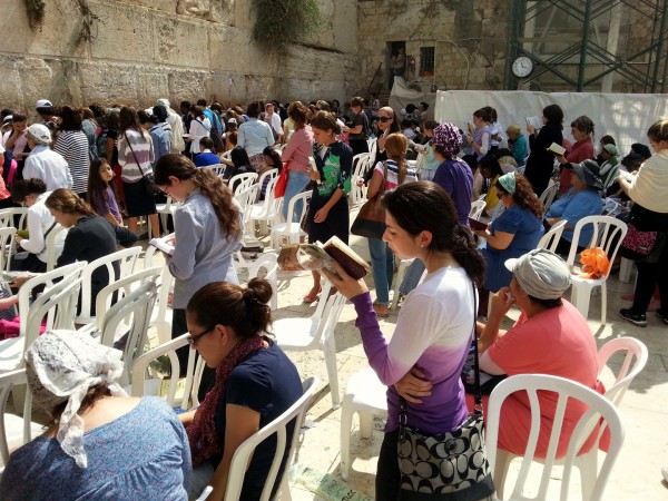 Jewish women pray at the Western Wall on Sukkot.