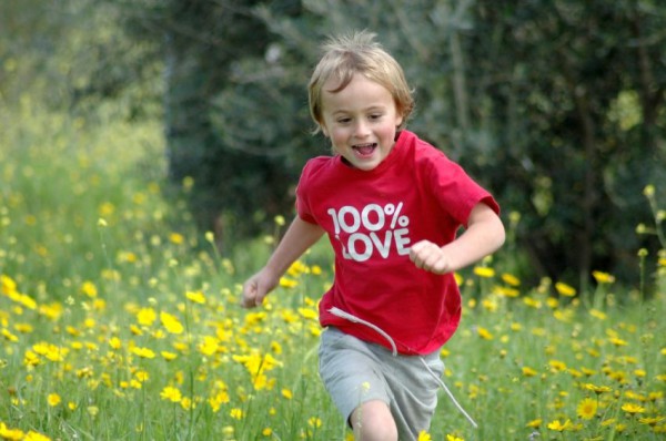 An Israeli lad runs through a meadow.