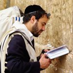 Jewish man prays Western Wailing Wall tefillin phylacteries tallit prayer shawl