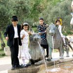 Orthodox siblings play at the Lions Fountain in Jerusalem