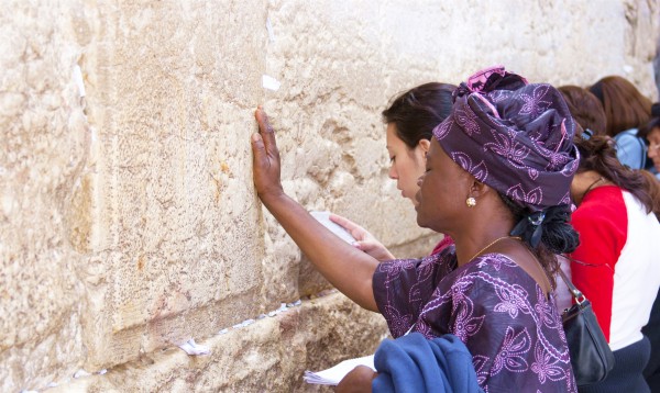 A woman touches the Wall as she prays in Jerusalem.