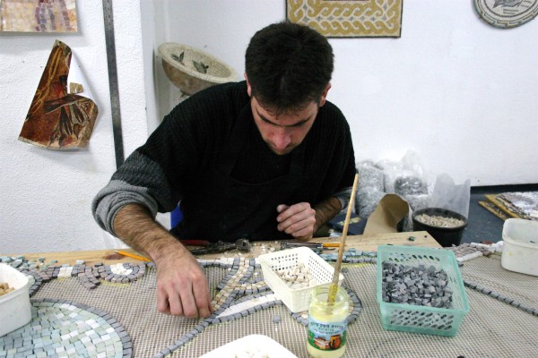 An Israeli artist fashions a mosaic.