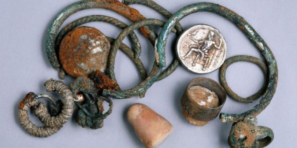 Cave explorers discovered a unique ancient treasure.  Pictured here are two coins of Alexander of Macedon, three rings, four bracelets, two decorated earrings, three other earrings  and a small stone weight. (Israel Antiquities Photo by Clara Amit)