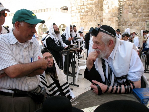 A Palestinian Christian and a Jewish Orthodox man have a discussion at the Western (Wailing) Wall in Jerusalem.