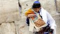 A 13-year-old Jewish boy pays respect to the Torah. (Ministry of Tourism photo taken by Yonatan Sindel, Flash 90)