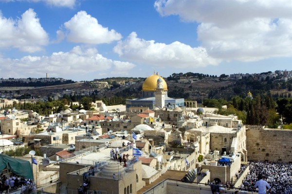 Crowds gather at the Western (Wailing) Wall in Jerusalem. Above the Wall is the Temple Mount. Just to the left of the Western Wall is the Muslim Dome of the Rock, which is thought to occupy the spot where the First and Second Jewish Temples were located.