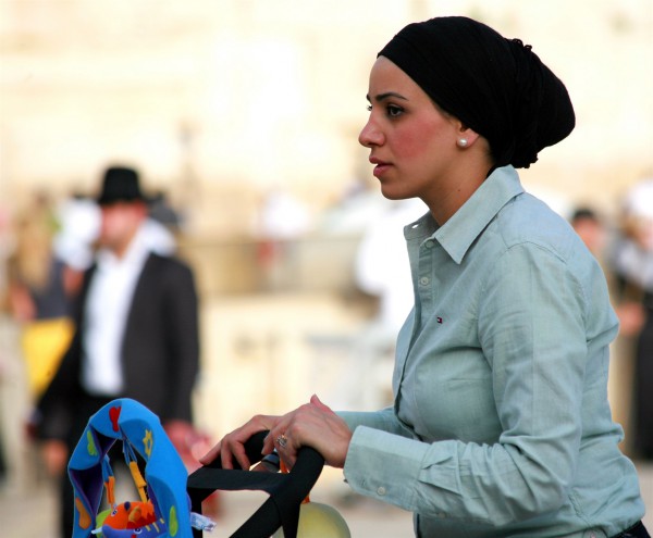 An Orthodox Jewish mother pushes a stroller in Jerusalem. (Photo by opalpeterliu)