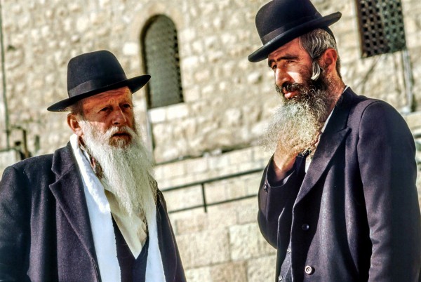 Two ultra-Orthodox Jewish men have a conversation in Jerusalem.