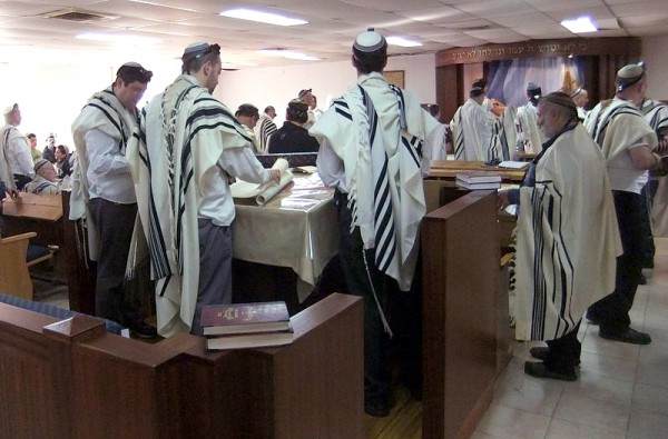 Jewish men read Scripture during morning prayer in an Israeli synagogue.