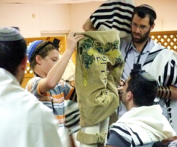 If the Torah scroll is not housed in a Torah tik (case), after the Torah reading, the Golel (roller) performs Gelila (rolling up). The Torah is then bound with a sash and covered with the Torah cover. The honor of being the Golel is sometimes given to a child under Bar Mitzvah age.