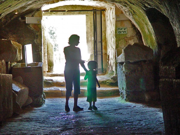 A mother and child visit the Cave of Coffins at Beit She'arim.