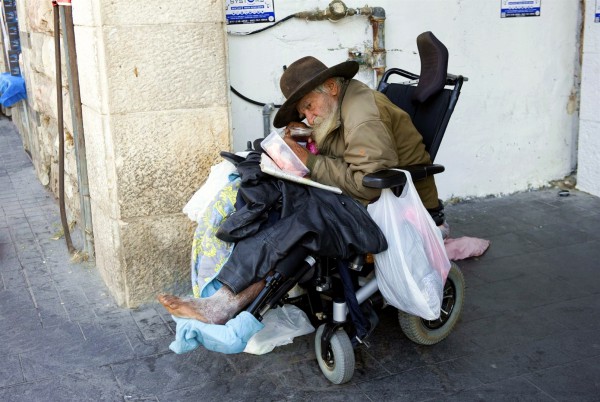 A homeless man in a wheelchair on a Jerusalem street.