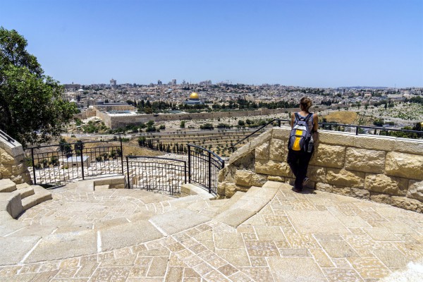 A woman looks toward the Temple Mount from the Mount of Olives.