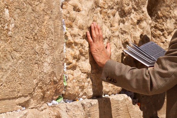 A man touches the Western (Wailing) Wall as he prays.