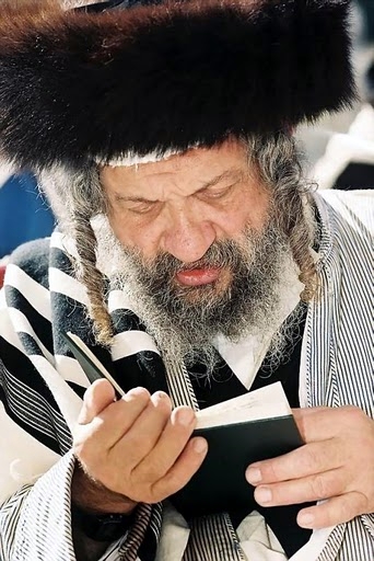 A Jewish man recites prayers.