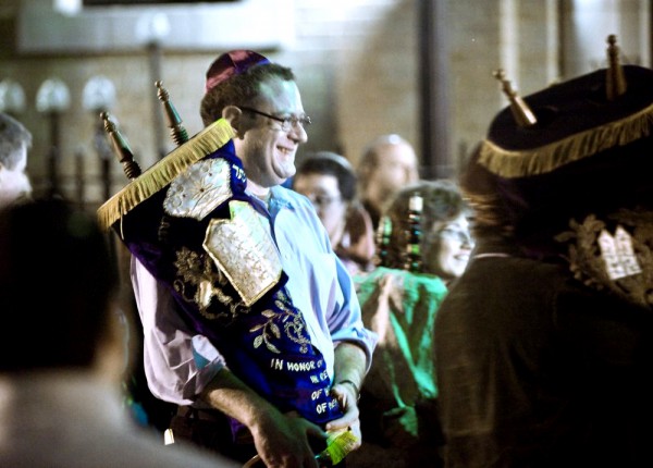 Torah scrolls are paraded in front of the United Synagogue of Hoboken on Simchat Torah. (Photo by Joe Epstein)