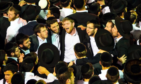 Chassidic men dance together in an expression of their joyful relationship with God and one another.