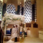 A Jewish man and woman exchange wedding vows under the chuppah. (Photo by Brett Lidder)