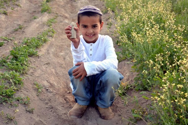 Uri Grinhot holds the statuette that he found.  (Photo by Moriah Grinhot)