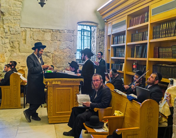 Orthodox worshipers pray, sing, play the violin, and dance in the synagogue at King David's Tomb.